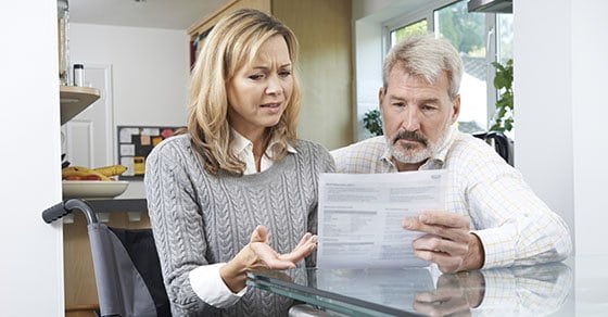 Frustrated Couple With Woman In Wheelchair Reading Letter