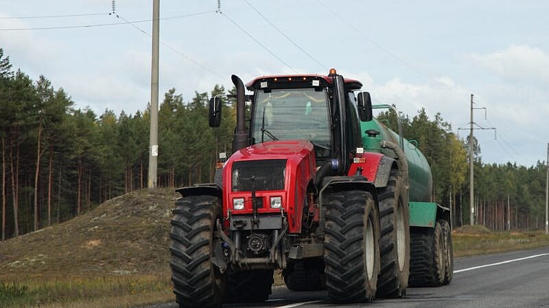 Big,Red,Wheeled,Tractor,With,Barrel,Drive,On,Country,Highway Big,Red,Wheeled,Tractor,With,Barrel,Drive,On,Country,Highway